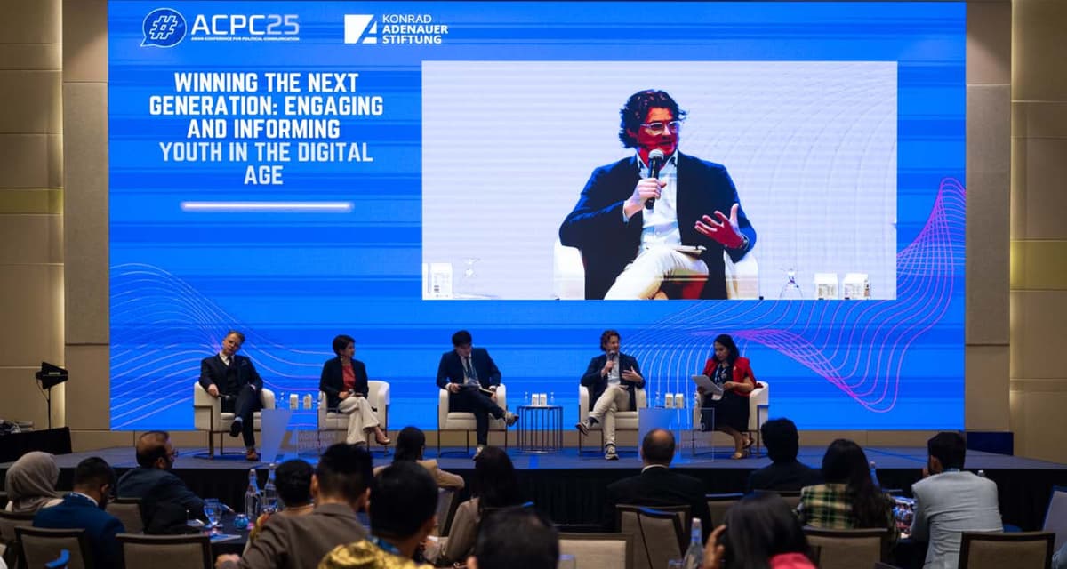 Panel discussion on "Winning the Next Generation" at ACP25 conference, with Ben Guerin and other speakers on stage and a large screen showing a presenter, audience seated in foreground