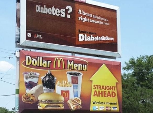 McDonald's billboard placed directly next to a diabetes awareness advertisement, illustrating ironic brand adjacency